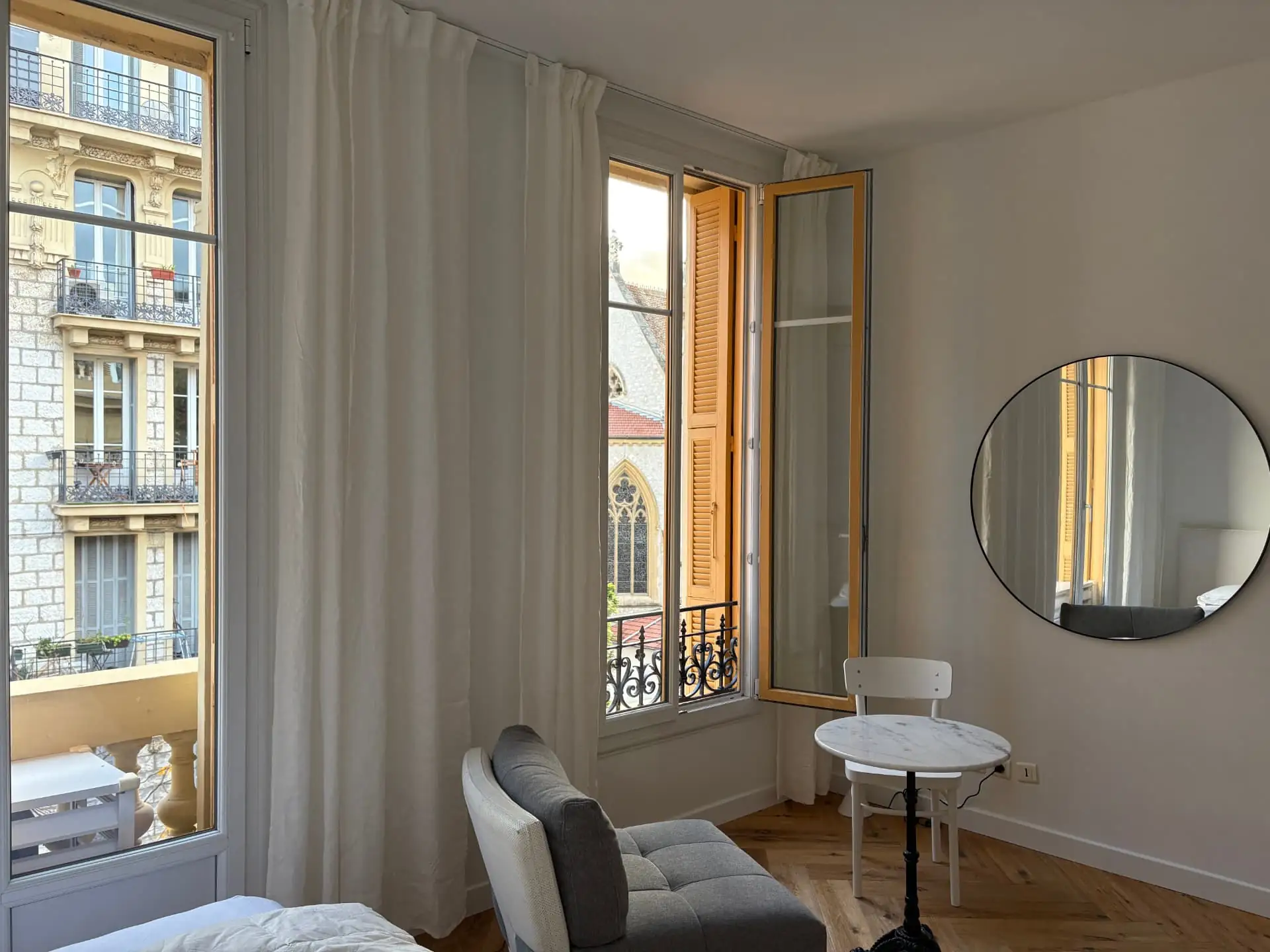 Kitchenette with hob, sink and fridge beside the studio's living corner and French window